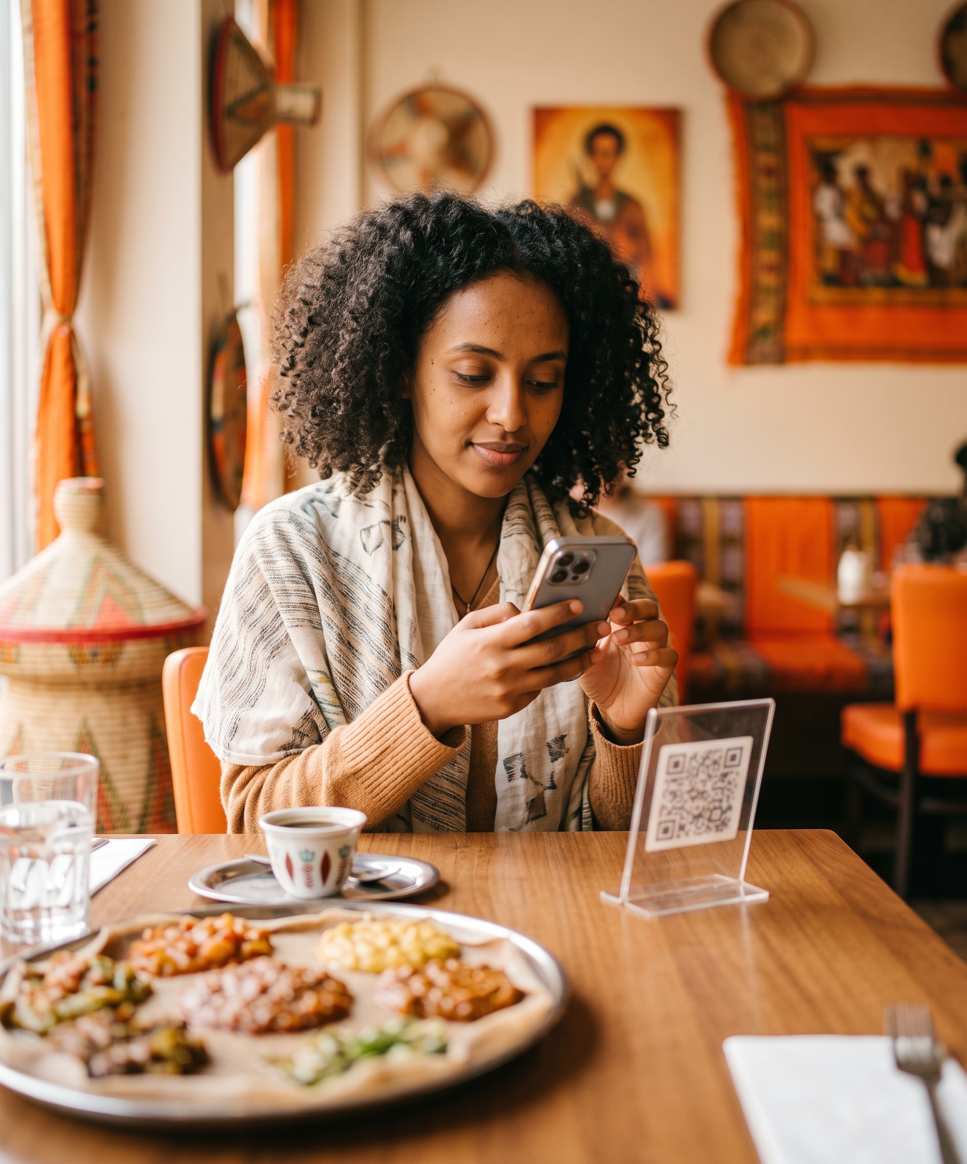 A guest scanning the table QR code with their phone in a restaurant